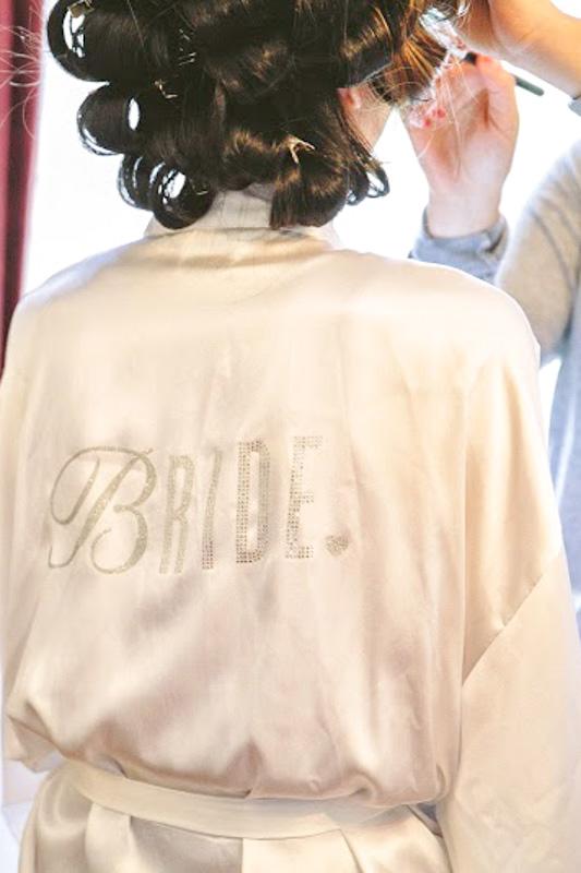 Photo of bride getting makeup