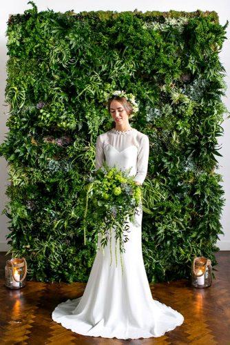 wedding backdrop ideas bride with greenary bouquet