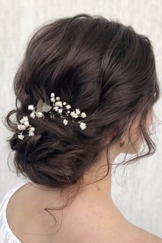 babys breath wedding ideas sinple low updo on curly dark hair with fresh flowers julia_alesionok