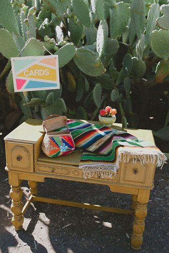 wedding taco bar a bedside table with a bright basket for cards and a striped napkin john newsome photography