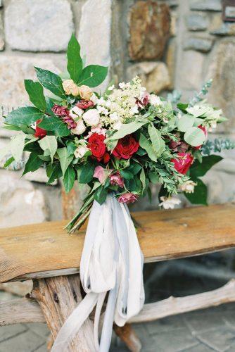 rustic wedding bouquet with0red0flower white tape codyhunterphotography