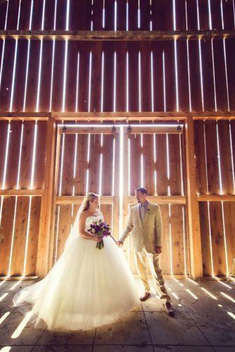 rustic wedding couple near gate adriencraven