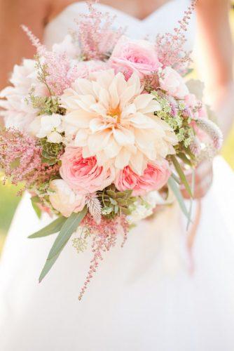 blush wedding bouquets with dahlias and roses in the hands of the bride katelyn james photography
