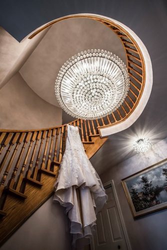 hanging wedding dress indoor on a ladder nogal photography