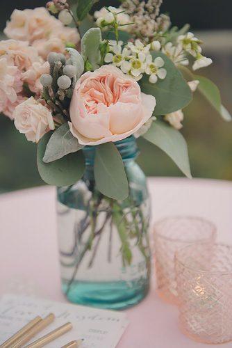 mason jars wedding centerpieces gentle pink flowers in blue glass rebecca amber photography via instagram