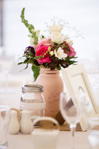 mason jars wedding centerpieces in the center of the table a beige jar with flowers beach blues