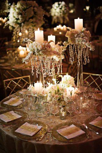 wedding centerpieces tall with white roses and greens and candles crystals gruber photographers