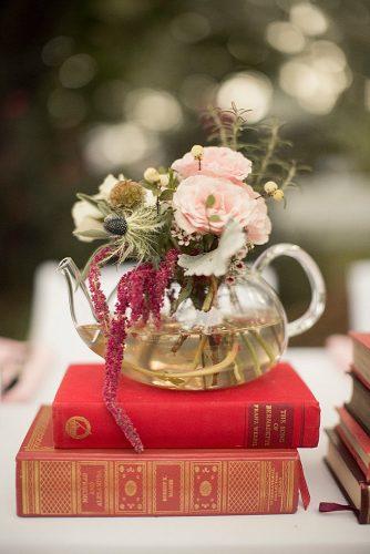 vintage teapot and teacup wedding ideas natural centerpieces autumn flowers pink roses in a transparent teapot on a pile of books mustard seed photography