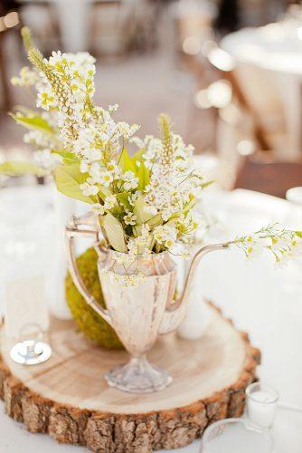 vintage teapot and teacup wedding ideas natural centerpieces white wildflowers in a kettle on a wooden cot elyse hall photography
