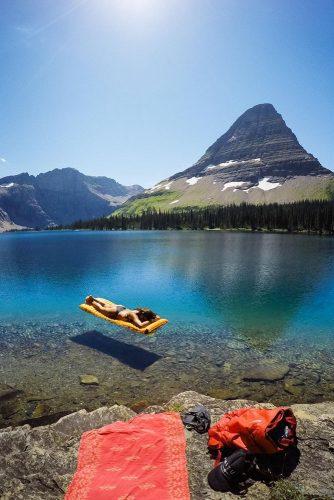 romantic honeymoon spots in us calm water and girl floating and getting sunbath in flathead lake montana