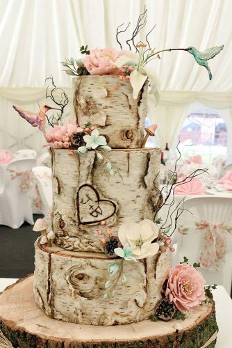 woodland themed wedding cakes birch bark with delicate flowers of mushrooms and hummingbirds and initials in the heart vicki via instagram