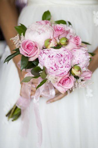 pink wedding bouquets with peonies roses astilbe and greens tied with a pink ribbon krista patton photography