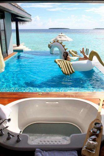 best honeymoon spots girl swims in pool on maldives