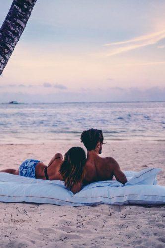cheap honeymoon ideas couple on the beach sunset amy seder
