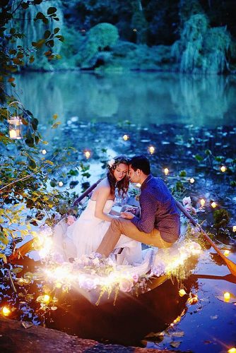 disney wedding the bride and groom in a boat with lights kay english photography