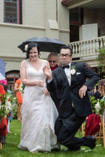 awkward wedding photos groom falls under the rain masika may photography