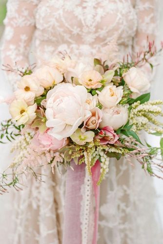 blush wedding bouquets with roses and wild flowers and peonies in the hands of the bride anna hoffmann farley via instagram