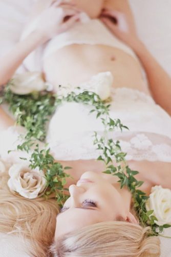 wedding boudoir book bride lying among the flowers love her photography