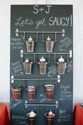 rustic barbecue bbq wedding stand with sauces and seasonings for barbecue natalie franke photography