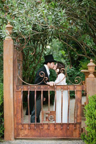 themed wedding photos pride and prejudice bride and groom kiss in the garden shannon morse