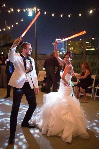 themed wedding photos star wars bride and groom dance with light saber caca santoro photography