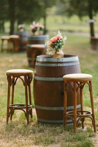 wine barrels a wine barrel is used as a table decorated with a golden vase with flowers adam cavanagh via instagram