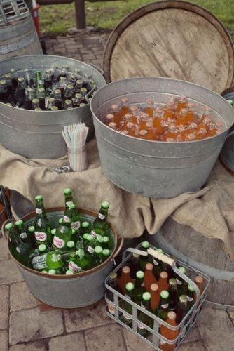 wine barrels bottles of beer in iron pails on wine barrels wildflowers photography