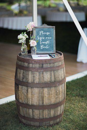 wine barrels guest book on a wine barrel flowers in transparent bottles booth photographics