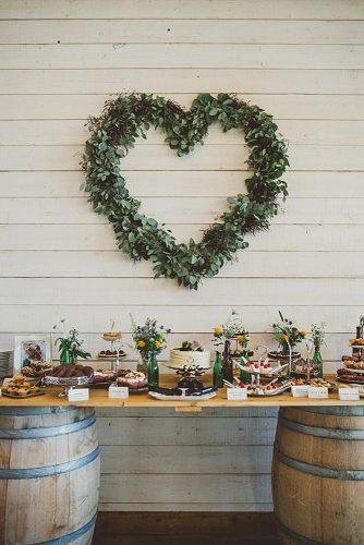 wine barrels reception wine barrels as footboards for a dessert table a wreath of greenery in the form of a heart ameris