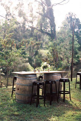 wine-barrels-table-of-wine-barrels-with-high-chairs-and-flowers-wooden-weddings-via-instagram