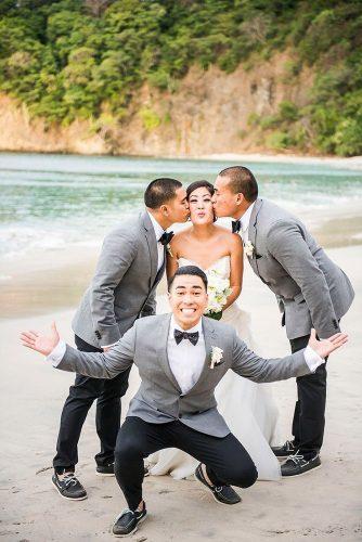 groomsmen photos bride with groomsmen on the beach storiesweddingphoto