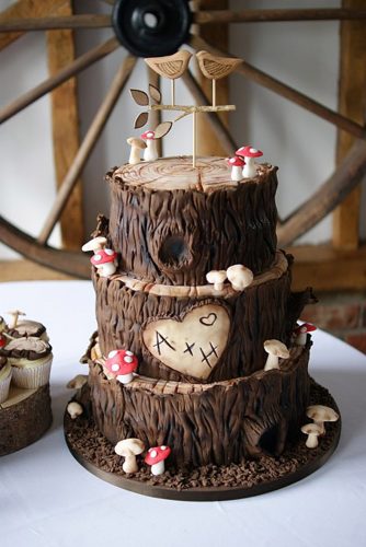woodland themed wedding cakes a brown three tier cake with initials in the heart with mushrooms mushrooms and derevyannyh birds on the top bake a lous