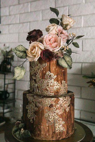 woodland themed wedding cakes brown with rolden décor and flowers on the top winifred kriste cake via instagram