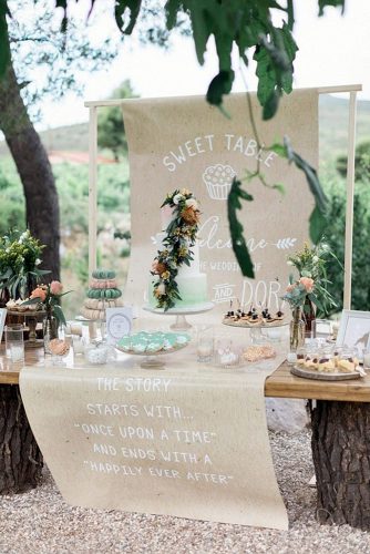 rustic backyard wedding decoration dessert table is decorated with an inscription and a green one based on wooden stumps sandy and odysseas