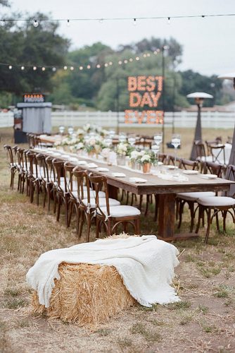 rustic backyard wedding decoration long wooden table with flowers on the background of the inscription from the lights bryan n miller photography