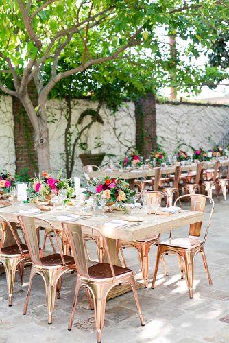 rustic backyard wedding decoration backyard reception with wooden flower table and rose gold chairs kaysha weiner