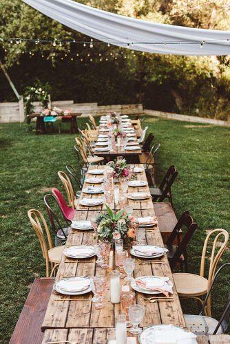 rustic backyard wedding decoration reception with long wooden table flower centerpieces steve cowell