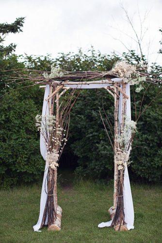 rustic backyard wedding decoration wooden arch with branches and babys breathe flowers sharon litchfield photography