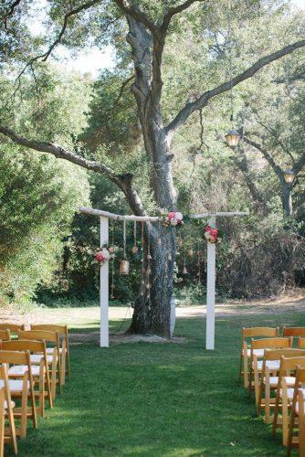 rustic backyard wedding simple wooden arch decorated with flowers and suspended details swoon by katie