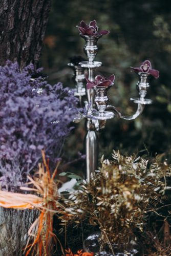 silver candlestick with orchids and dried flowers lorena erre photography