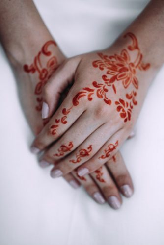 the brides hands are painted with mandy lorena erre photography