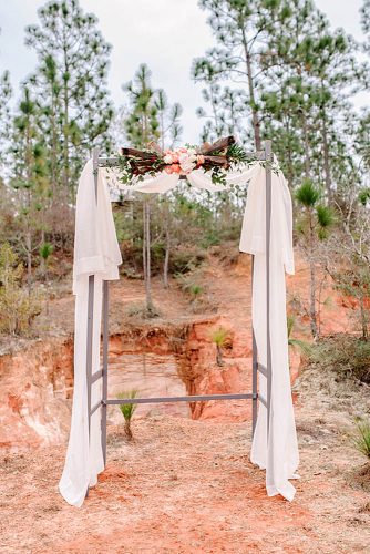 western wedding decoration arch with white cloth flowers and wood rae marshall weddings