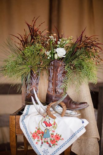 western wedding decoration greens and white flowers in cowboy boots chris and kristen photography