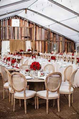 western wedding decoration reception under barn tent with red roses chris and kristen photography