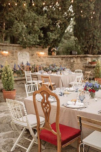 western wedding decoration tables with light tablecloths of wild flowers and different chairs pablo_laguia via instagram