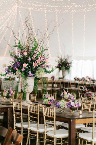 western wedding decoration under white tent wooden tables decorated with luxurious lilac flowers mark williams studio