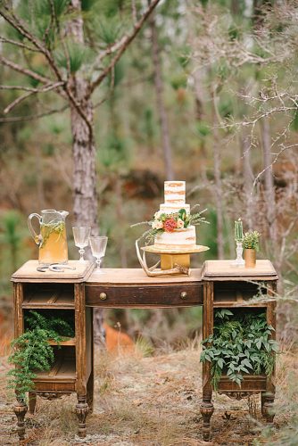 western wedding decoration vintage writing table with cake decorated with greenery rae marshall weddings