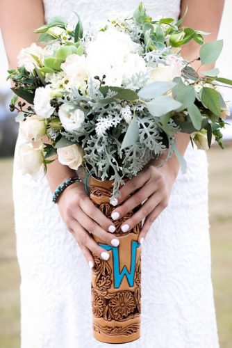 western wedding decoration white bouquet in a leather case with monogram flying w leather via instagram