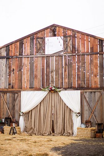 western wedding decoration the entrance to the barn is decorated with burlap flowers and horns chris and kristen photography