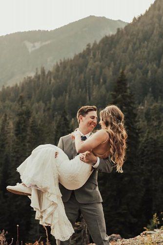 couple poses bride in grooms arms tessatadlock